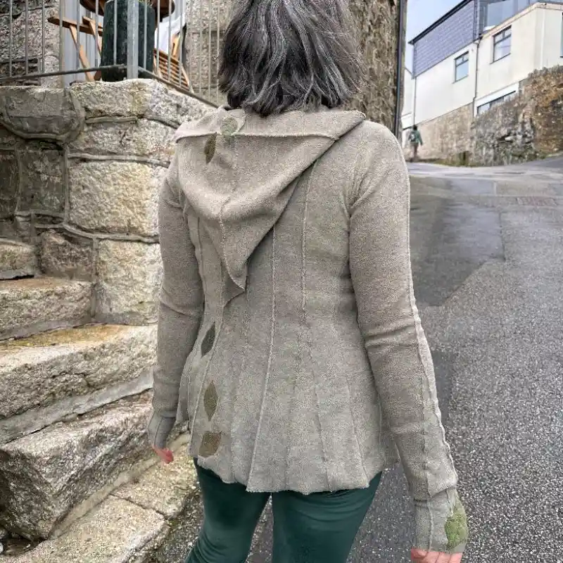 a back view of a Feeline Clothing hooded top with appliquéd leaves and leaf mittens, in soft neutral shades and soft greens