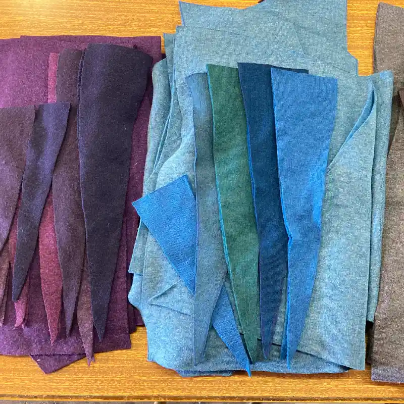 two Feeline clothing tops cut out and ready to sew up. one is shades of blue the other is shades of purple