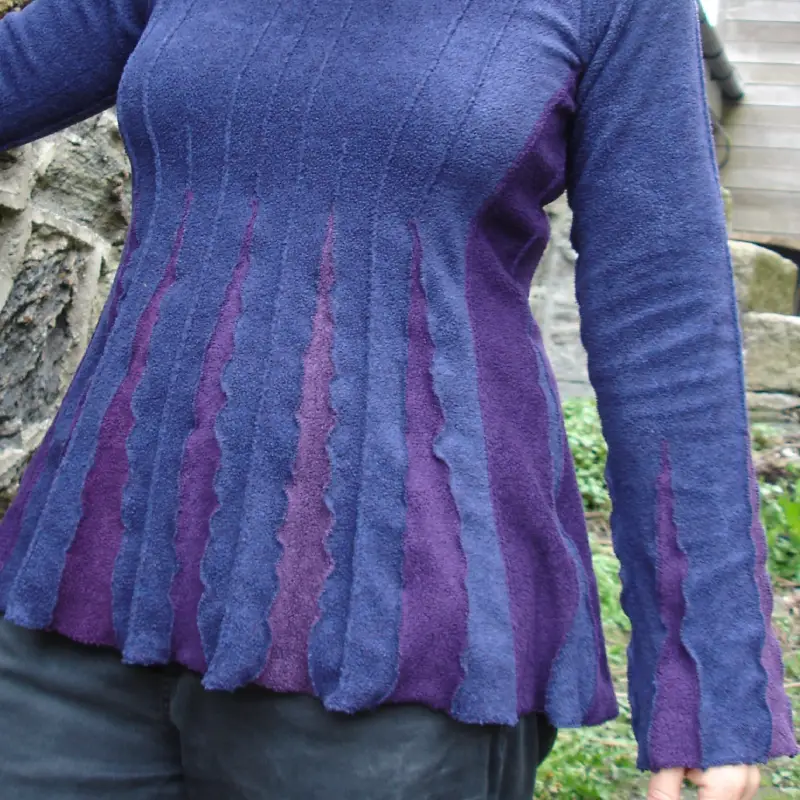 close up detail of a Feeline Clothing top in bluebell colour way, of purely blue and violet , showing the contrast of two colours used together.