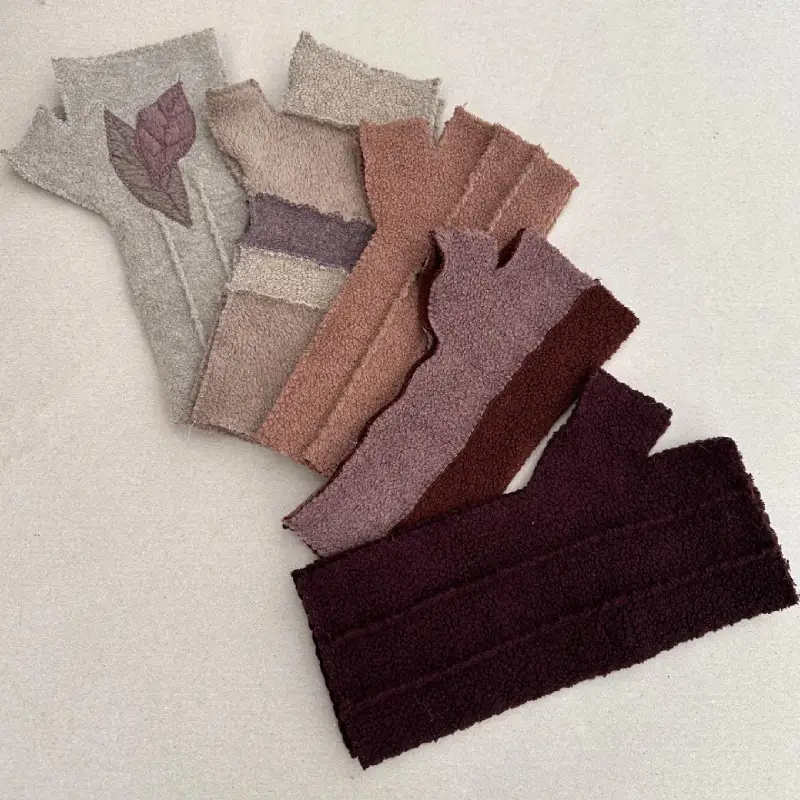 5 pairs of Feeline Clothing mittens, in 4 of the styles available, in various shades of brown, from light fawn to dark chocolate