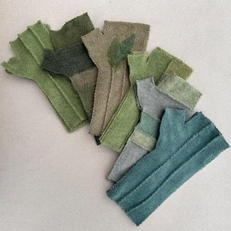 6 pairs of Feeline clothing mittens showing 4 of the available styles. in a range of colours and shades, from aqua, to green to fawn.