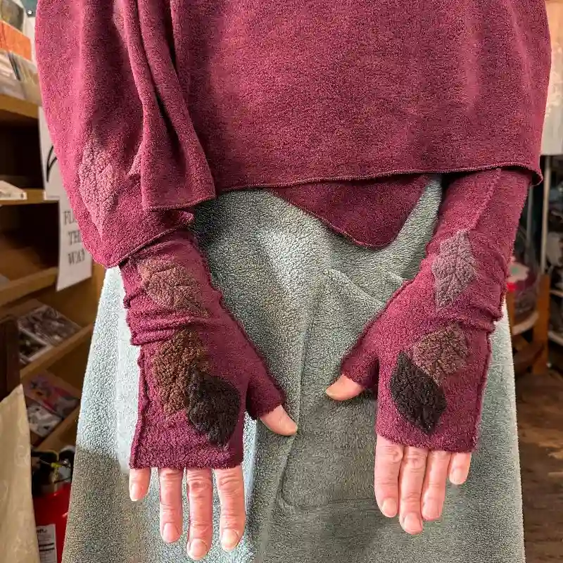 close up of Feelne Clothing shawl and mitts with appliquéd leaves onto a rich wine colour