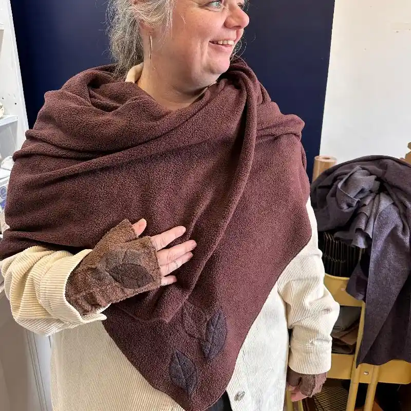 Feeline Clothing shawl and mittens in rich brown, with appliquéd leaves, modelled by a ceramic maker