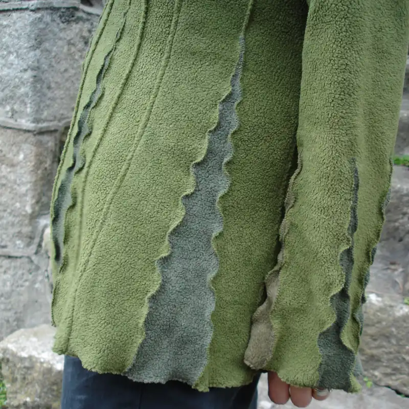 detail of a Feeline Clothing top in fern colour way, showing the insert details at hem and bottom of sleeve