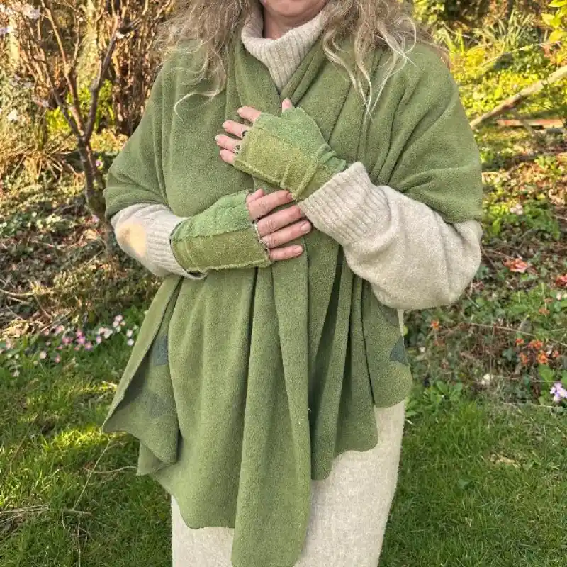 Feeline Clothing green scarf/wrap and two tone mittens being worn with a long cream jumper dress in a garden setting