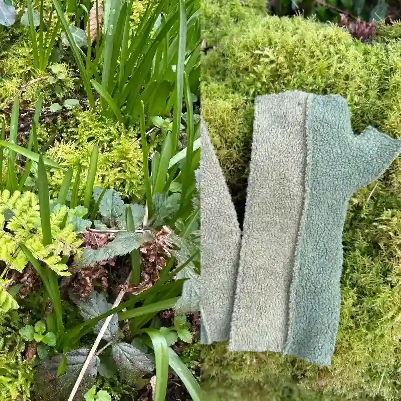 composite image juxtaposing a photo of ferns and bluebell leaves, with a two tone Feeline Clothing mitten in greens, resting on a mossy wall