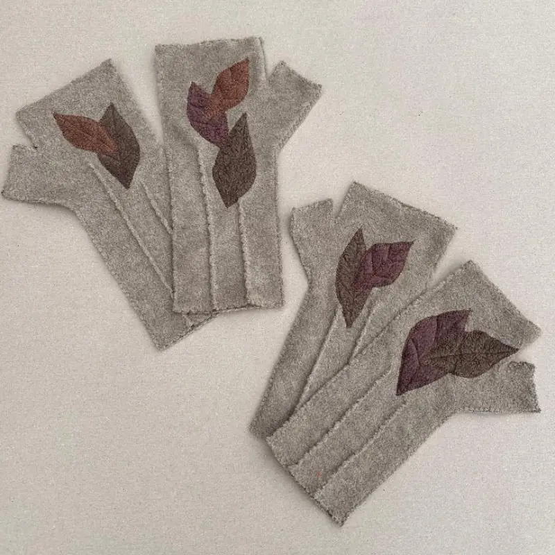 2 pairs of Feeline Clothing mittens, in soft fawn, with brown leaves appliquéd on. showing how a different number of leaves can be used,
