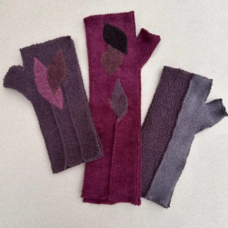 3 pairs of Feeline Clothing mittens, showing the various lengths available. 2 leaf pairs and 1 tow-tone pair. in shades and he's from the warmer side of the colour palette.