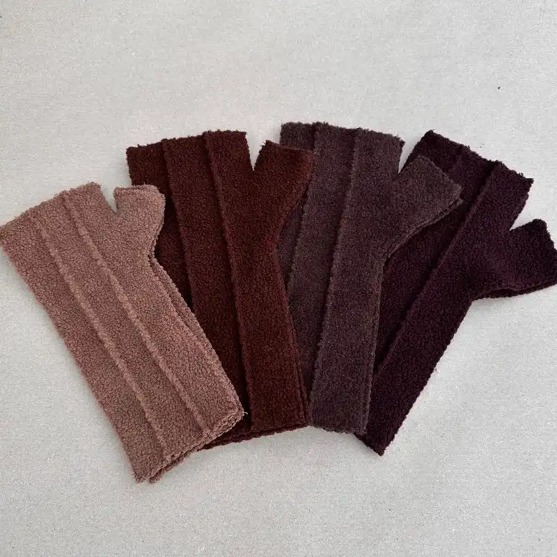 4 pairs of Feeline Clothing mittens, in the original design. showing a range of the brown shades available.
