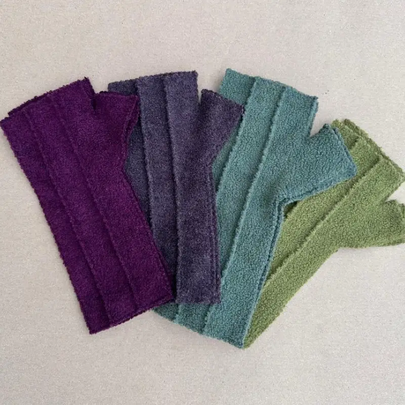4 pairs of the original style of FEeline Clothing mittens, in green aqua soft grey/purple and deep violet/purple.