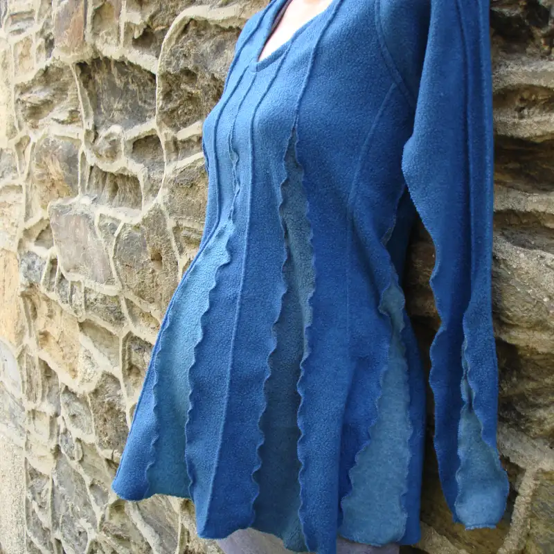 Feeline Clothing top in deep sea colour way, modelled on a pregnant mannequin against a stone wall