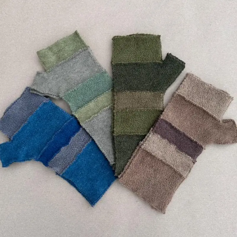 4 pairs of striped Feeline Clothing mittens, showing some of the range of colours available. fawns, khaki and olive green, soft paler green and aqua, and stronger blues and grey.